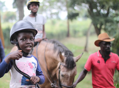 Guided kids pony rides Children doing a pony ride with guides walking